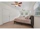 Bedroom featuring carpet, ceiling fans, multiple windows and a door at 1501 Memory Se Ln, Smyrna, GA 30080