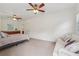 Bedroom featuring carpet, ceiling fans, multiple windows, a kitchenette and a couch at 1501 Memory Se Ln, Smyrna, GA 30080