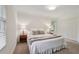 A cozy bedroom features neutral tones, carpeted floors, and bright natural light from a window at 1501 Memory Se Ln, Smyrna, GA 30080