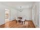 Cozy dining area featuring hardwood floors, modern chandelier, and access to kitchen at 1501 Memory Se Ln, Smyrna, GA 30080