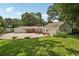 Wide view of the brick ranch-style house featuring an expansive, well-manicured lawn and mature trees at 1501 Memory Se Ln, Smyrna, GA 30080