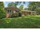 Well-maintained brick house with lush landscaping, inviting porch and a long driveway at 1501 Memory Se Ln, Smyrna, GA 30080