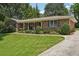 Attractive brick home featuring manicured landscaping and an inviting covered porch at 1501 Memory Se Ln, Smyrna, GA 30080