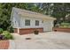 Detached one car garage with a brick base and cement driveway in a wooded setting at 1501 Memory Se Ln, Smyrna, GA 30080