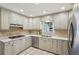 Well-lit kitchen featuring stainless steel appliances, neutral cabinets and tile flooring at 1501 Memory Se Ln, Smyrna, GA 30080