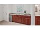 Kitchenette featuring wood cabinets, granite countertop, stainless mini-fridge, window, and access to bathroom at 1501 Memory Se Ln, Smyrna, GA 30080