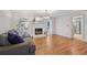 Inviting living room with fireplace, modern lighting, and hardwood floors throughout at 1501 Memory Se Ln, Smyrna, GA 30080