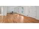 Bright living room with hardwood floors, white walls, and natural light from large windows at 1501 Memory Se Ln, Smyrna, GA 30080