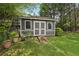A backyard shed with double doors and a ramp, providing practical storage and enhancing the property's appeal at 1501 Memory Se Ln, Smyrna, GA 30080