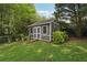 A shed in a fenced backyard, offering storage space and an inviting feature for potential homeowners at 1501 Memory Se Ln, Smyrna, GA 30080