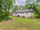 Back exterior of home featuring well-kept yard, painted brick and stone foundation at 2203 Second Ave, Decatur, GA 30032