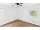 Bright bedroom featuring a ceiling fan, wood-look floors, and plenty of natural light from two windows at 2203 Second Ave, Decatur, GA 30032