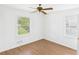 Bright bedroom featuring a ceiling fan, wood-look floors, and plenty of natural light from two windows at 2203 Second Ave, Decatur, GA 30032