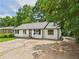 Charming single-story home with white painted brick, mature trees, and a private driveway at 2203 Second Ave, Decatur, GA 30032