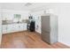 A modern kitchen featuring white cabinets, stainless steel appliances, and wood-look floors at 2203 Second Ave, Decatur, GA 30032