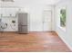 A kitchen with white cabinets, stainless steel refrigerator, wood-look floors and access to the back door at 2203 Second Ave, Decatur, GA 30032