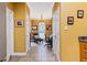 Hallway leading to sitting room with neutral tile flooring, white trim, and warm, golden-yellow painted walls at 3071 Lenox Ne Rd # 19, Atlanta, GA 30324
