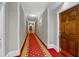 Long hallway with detailed trim, carpet, and wooden door at 3071 Lenox Ne Rd # 19, Atlanta, GA 30324