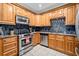 Updated kitchen features stainless steel appliances, granite counters, tile backsplash, and light wood cabinets at 3071 Lenox Ne Rd # 19, Atlanta, GA 30324