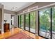 Sitting room features hardwood floors, large windows, and patio access with views of the greenery at 3071 Lenox Ne Rd # 19, Atlanta, GA 30324