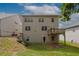 Rear exterior view with a wooden deck, walkout basement, and spacious backyard at 565 Lance View Ln, Lawrenceville, GA 30045