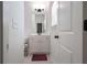 Well-lit bathroom featuring a vanity with white cabinets, mirror, and a neutral color scheme at 565 Lance View Ln, Lawrenceville, GA 30045