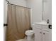 Bathroom features a vanity with storage and a shower with a neutral-toned curtain at 565 Lance View Ln, Lawrenceville, GA 30045