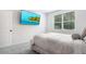 Clean bedroom features a plush bed with an accent wall and a view out the window at 565 Lance View Ln, Lawrenceville, GA 30045