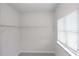 Walk-in closet with a window and white shelving at 565 Lance View Ln, Lawrenceville, GA 30045