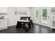 Bright dining area has a modern table and chairs and french doors to the backyard at 565 Lance View Ln, Lawrenceville, GA 30045