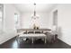 Bright dining area features wainscoting, dark wood floors, and modern chandelier at 565 Lance View Ln, Lawrenceville, GA 30045