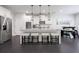 Open kitchen features a large center island with pendant lights and white cabinets with stainless appliances at 565 Lance View Ln, Lawrenceville, GA 30045