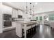 Modern kitchen with white cabinets, granite countertops, and a large center island with seating at 565 Lance View Ln, Lawrenceville, GA 30045