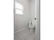 Neat water closet with white fixtures and modern light gray flooring at 565 Lance View Ln, Lawrenceville, GA 30045