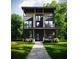 Modern two-story home featuring large windows, a sleek black facade, and lush greenery at 655 Willoughby Ne Way, Atlanta, GA 30312