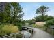 Scenic view of a park featuring a bridge, walking path, pond, and mature trees at 655 Willoughby Ne Way, Atlanta, GA 30312