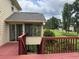 Home's outdoor deck with view of the backyard and screened porch at 25 Darcee Ct, Lawrenceville, GA 30046