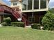 Brick home with a deck, screened porch, and a well-manicured lawn at 25 Darcee Ct, Lawrenceville, GA 30046