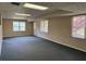 Spacious finished basement with neutral carpeting and natural light from multiple windows at 25 Darcee Ct, Lawrenceville, GA 30046