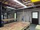 Unfinished basement offering utilities, storage, and workspace potential with shelving at 25 Darcee Ct, Lawrenceville, GA 30046