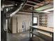 Unfinished basement area featuring a workbench, storage shelving, and utility hookups at 25 Darcee Ct, Lawrenceville, GA 30046