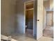 Bathroom featuring a walk-in shower, decorative wallpaper and tile flooring at 25 Darcee Ct, Lawrenceville, GA 30046