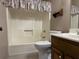 Cozy bathroom with a shower-tub combo, toilet, and vanity with storage at 25 Darcee Ct, Lawrenceville, GA 30046