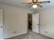 Cozy bedroom featuring neutral walls, ceiling fan, and doorway to the upper level at 25 Darcee Ct, Lawrenceville, GA 30046