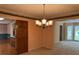 Dining room with wallpaper, carpet, stylish chandelier, and access to the kitchen at 25 Darcee Ct, Lawrenceville, GA 30046