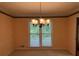 Dining room with decorative wallpaper, carpet flooring, and a stylish chandelier at 25 Darcee Ct, Lawrenceville, GA 30046