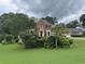 A traditional two-story brick home with a well-manicured front lawn and mature trees at 25 Darcee Ct, Lawrenceville, GA 30046
