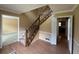 Inviting foyer features hardwood floors, wooden staircase, and natural light at 25 Darcee Ct, Lawrenceville, GA 30046