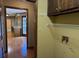 Functional laundry room features a utility sink, shelving, and connections for appliances at 25 Darcee Ct, Lawrenceville, GA 30046