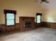 Spacious living room featuring a classic brick fireplace, wainscotting, and large windows at 25 Darcee Ct, Lawrenceville, GA 30046